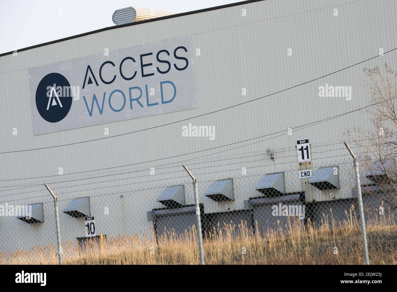 A logo sign outside of a facility occupied by Access World in Edgemere ...