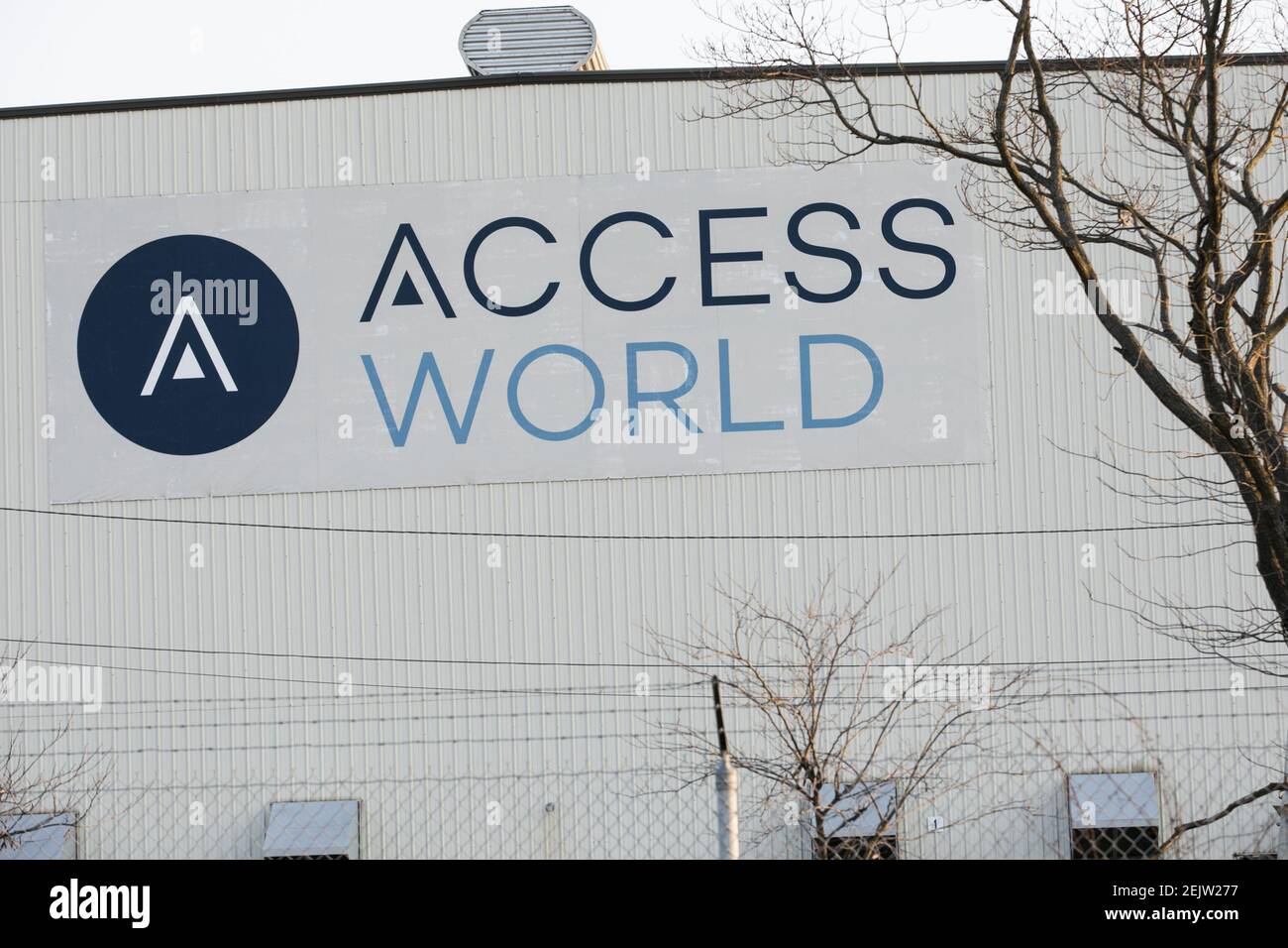 A logo sign outside of a facility occupied by Access World in Edgemere ...