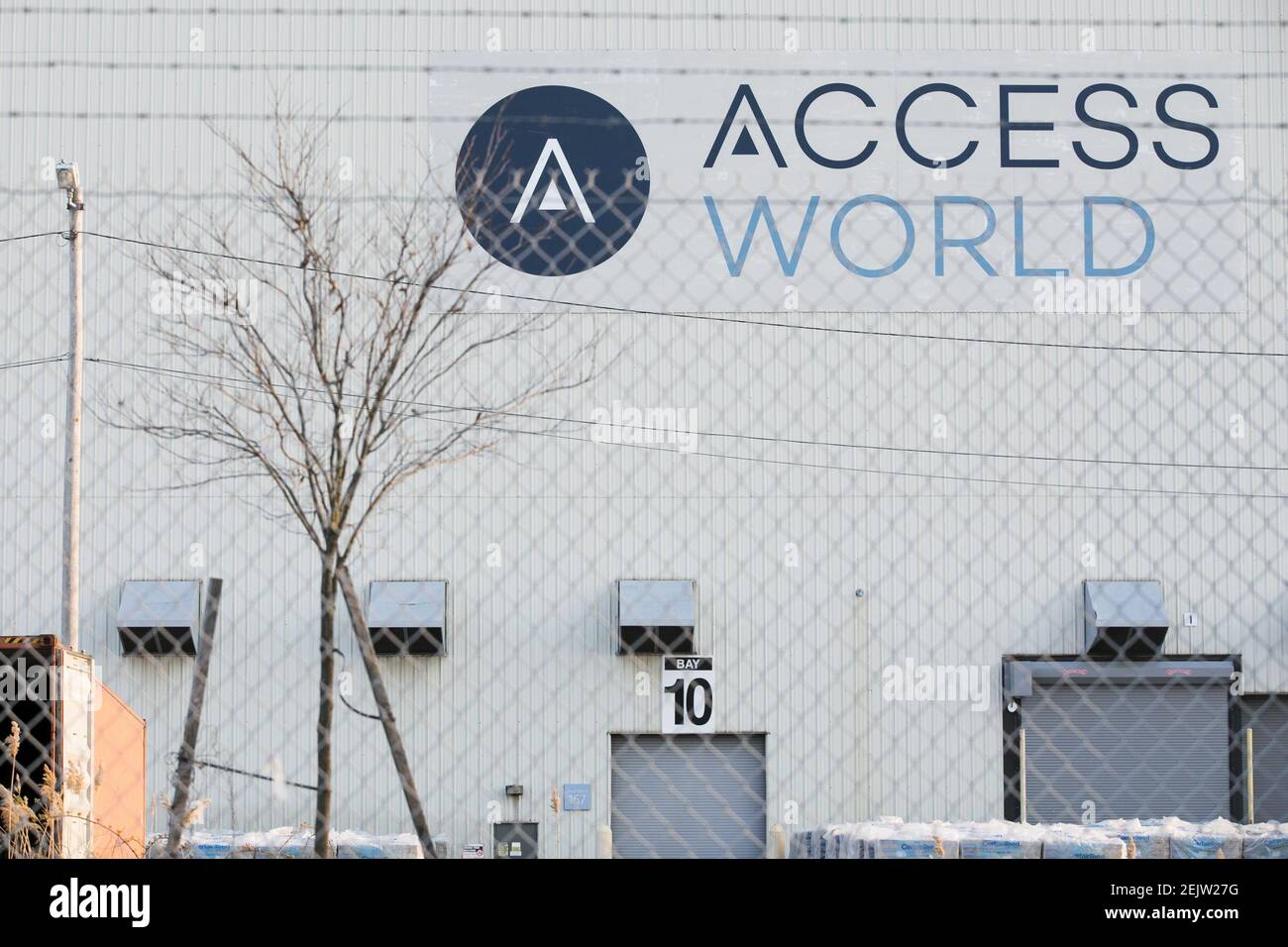 A logo sign outside of a facility occupied by Access World in Edgemere ...