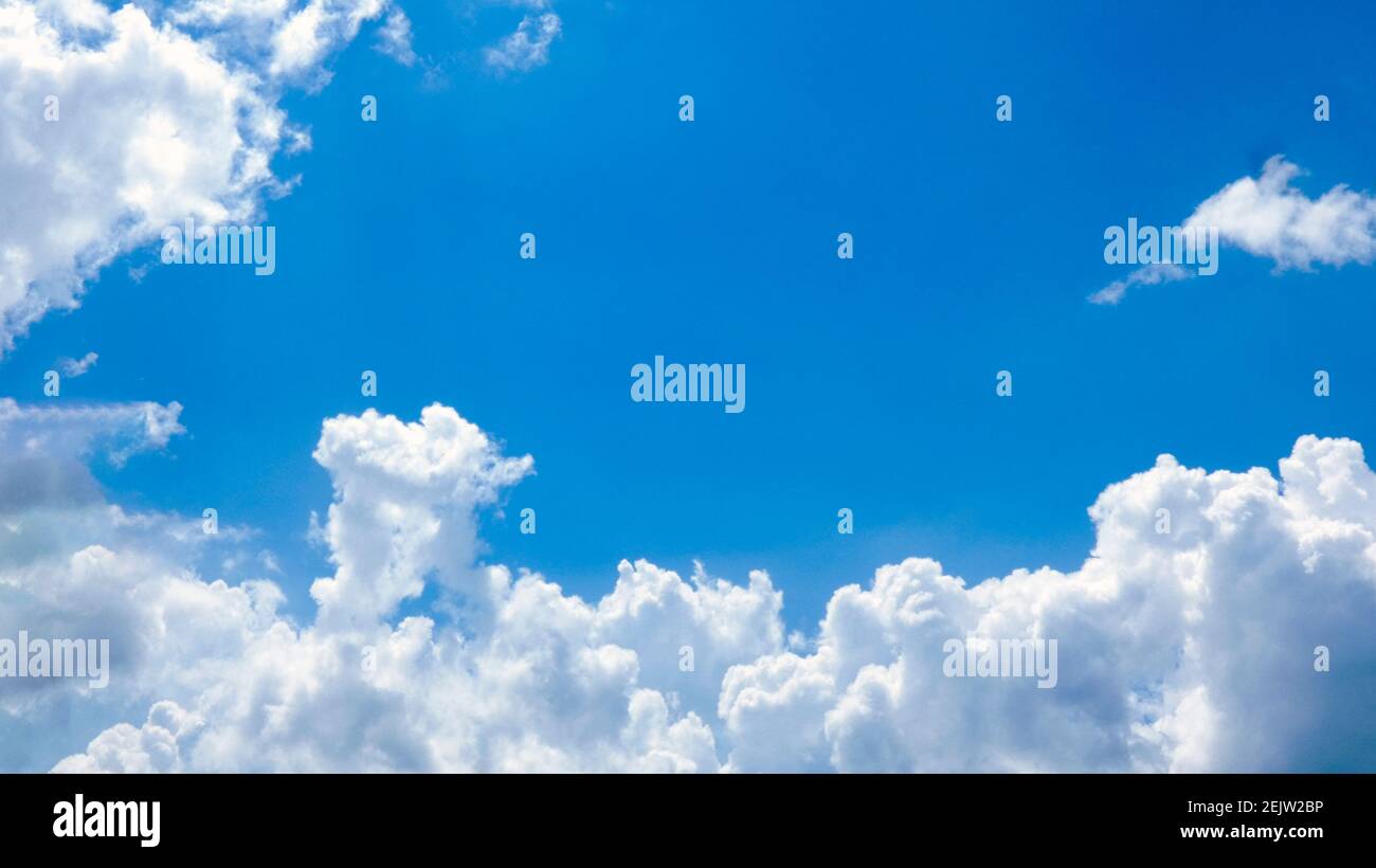 Blue sky with white beautiful clouds in a sunny day picture image background photography Stock Photo