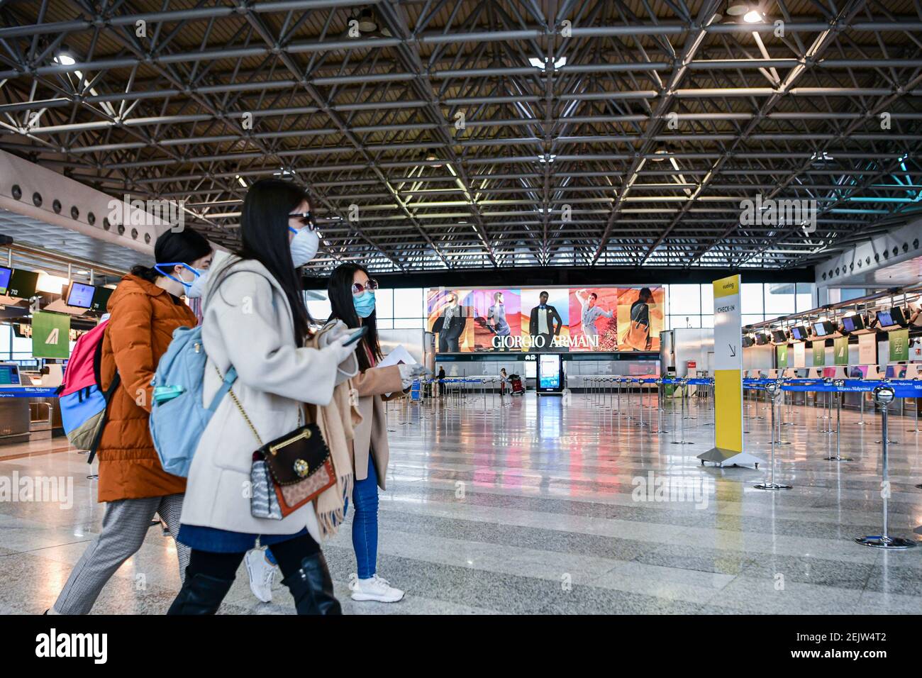 Milan Malpensa Airport, Italy - March 12, 2020: Passengers wearing ...