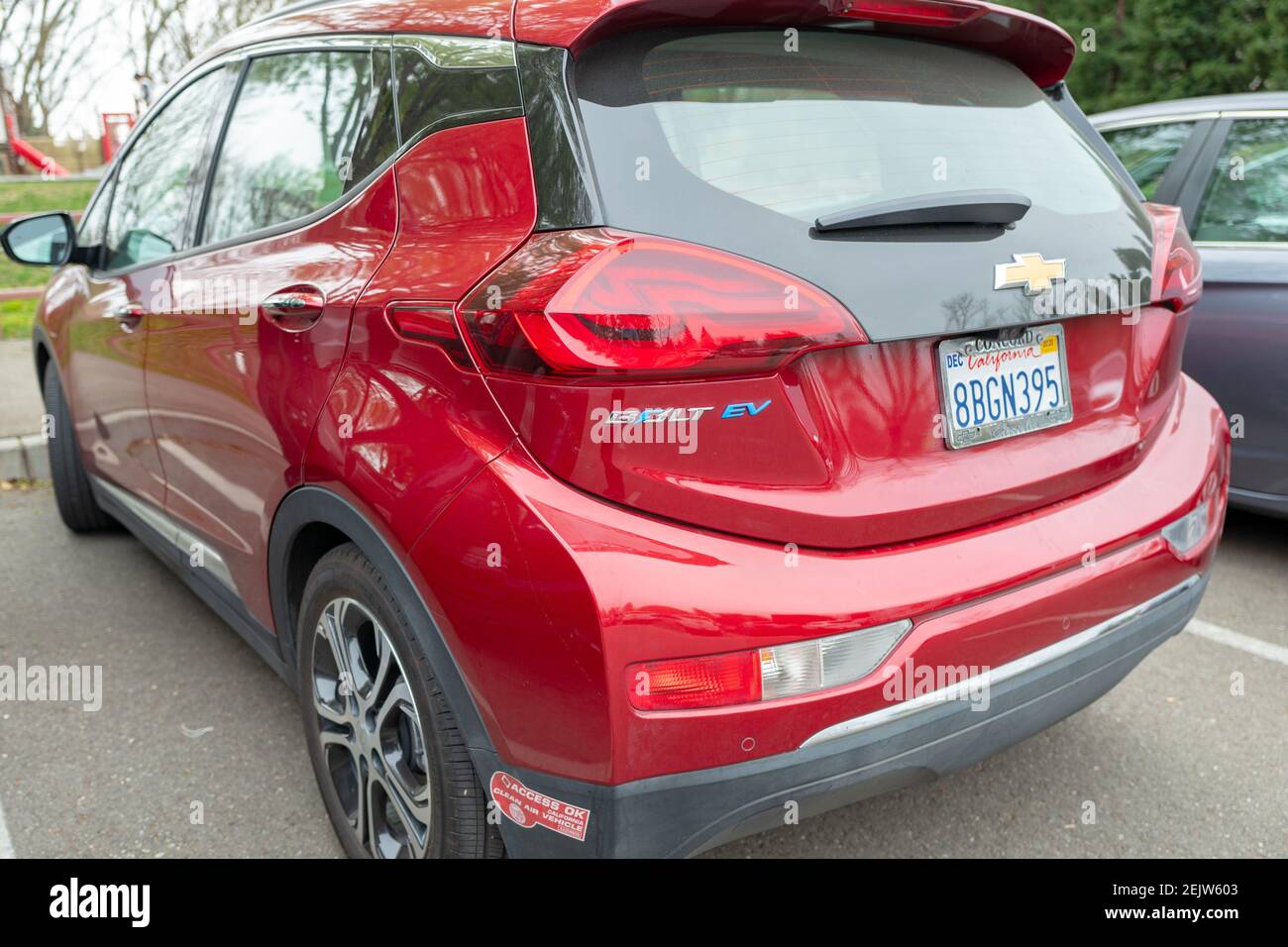 View from behind of red Chevrolet Bolt electric car, with logo and