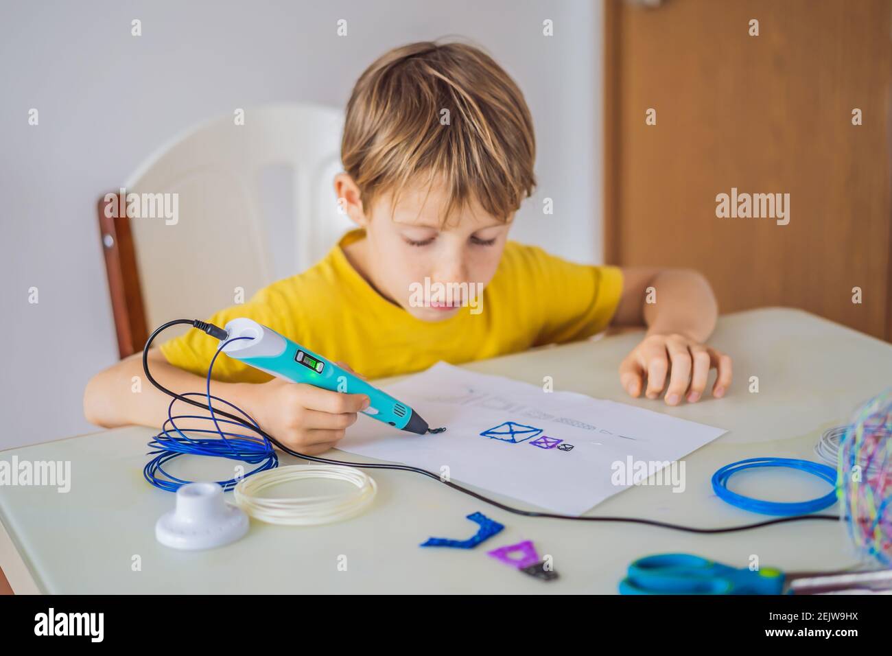 Kid using 3d printing drawing pen. Creative, leisure, technology education concept Stock Photo