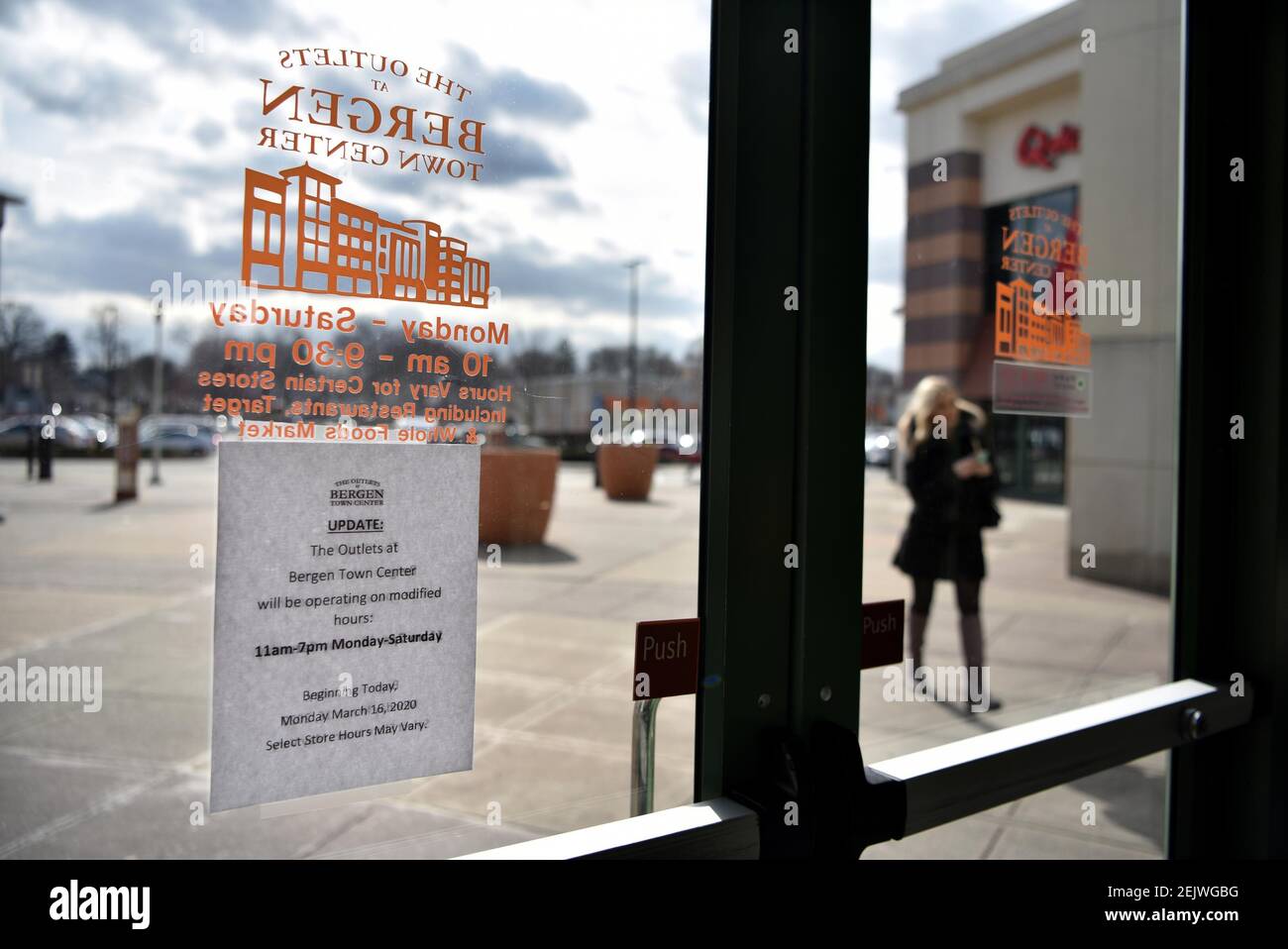 Mar 16, 2020; Paramus, NJ, USA; A sign on the front door to The Outlets at Bergen Town Center in Paramus announces the malls shortened hours starting Monday, March 16, 2020. New Jersey Gov. Phil Murphy urged all residents to stay home after 8 p.m. Mandatory Credit: Amy Newman/North Jersey.com via USA TODAY NETWORK/Sipa USA Stock Photo