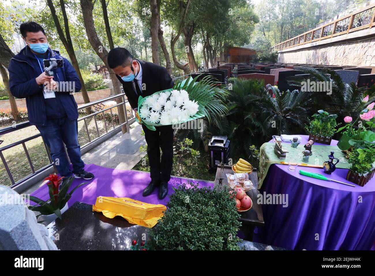 A staff of a local cemetery does online tomb sweeping and worshiping to memorize the deceased