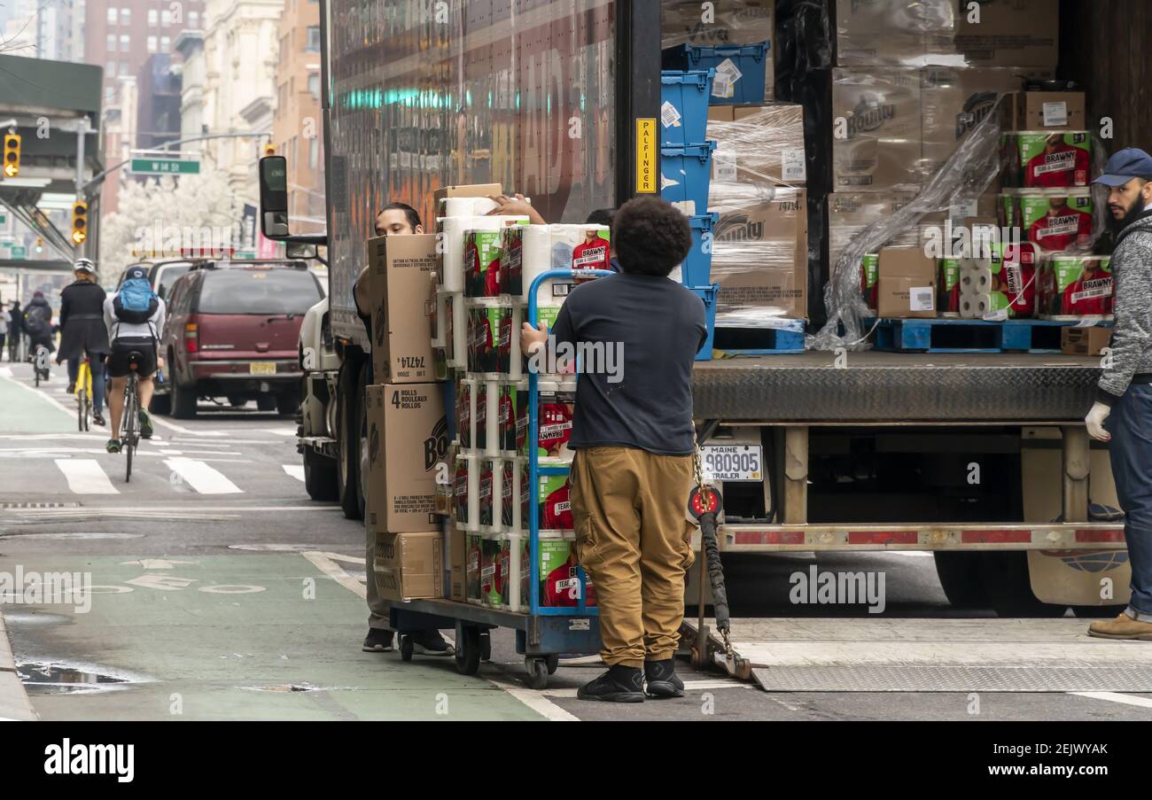 Workers unload a bountiful supply of Bounty and other brand paper