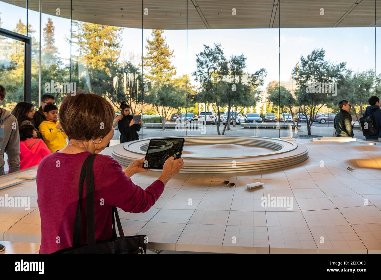 A customer using an iPad for an augmented reality (AR) tour to see a  virtual version of the Apple Park campus at the Apple Park Visitor Center  in Cupertino. (Photo by Alex