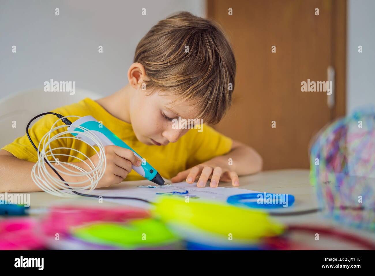 Kid using 3d printing drawing pen. Creative, leisure, technology education concept Stock Photo