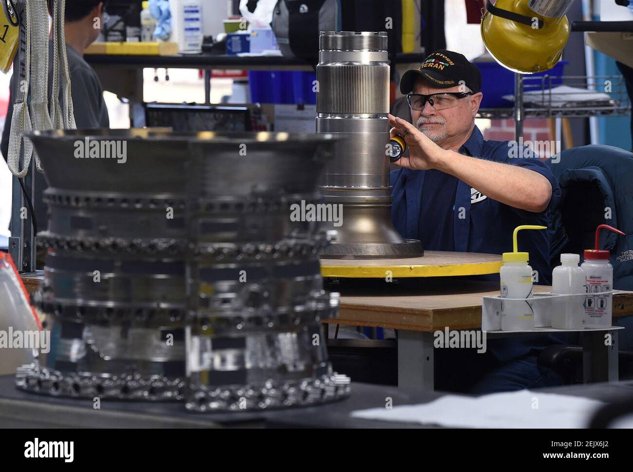Turbine Controls MRO employee Jim Clark inspects a turbine drive shaft