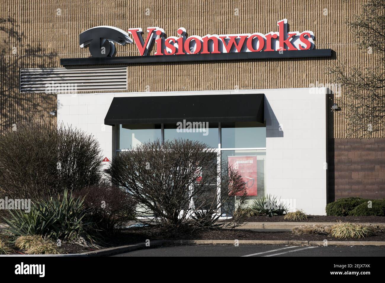 A logo sign outside of a Visionworks retail store location in North
