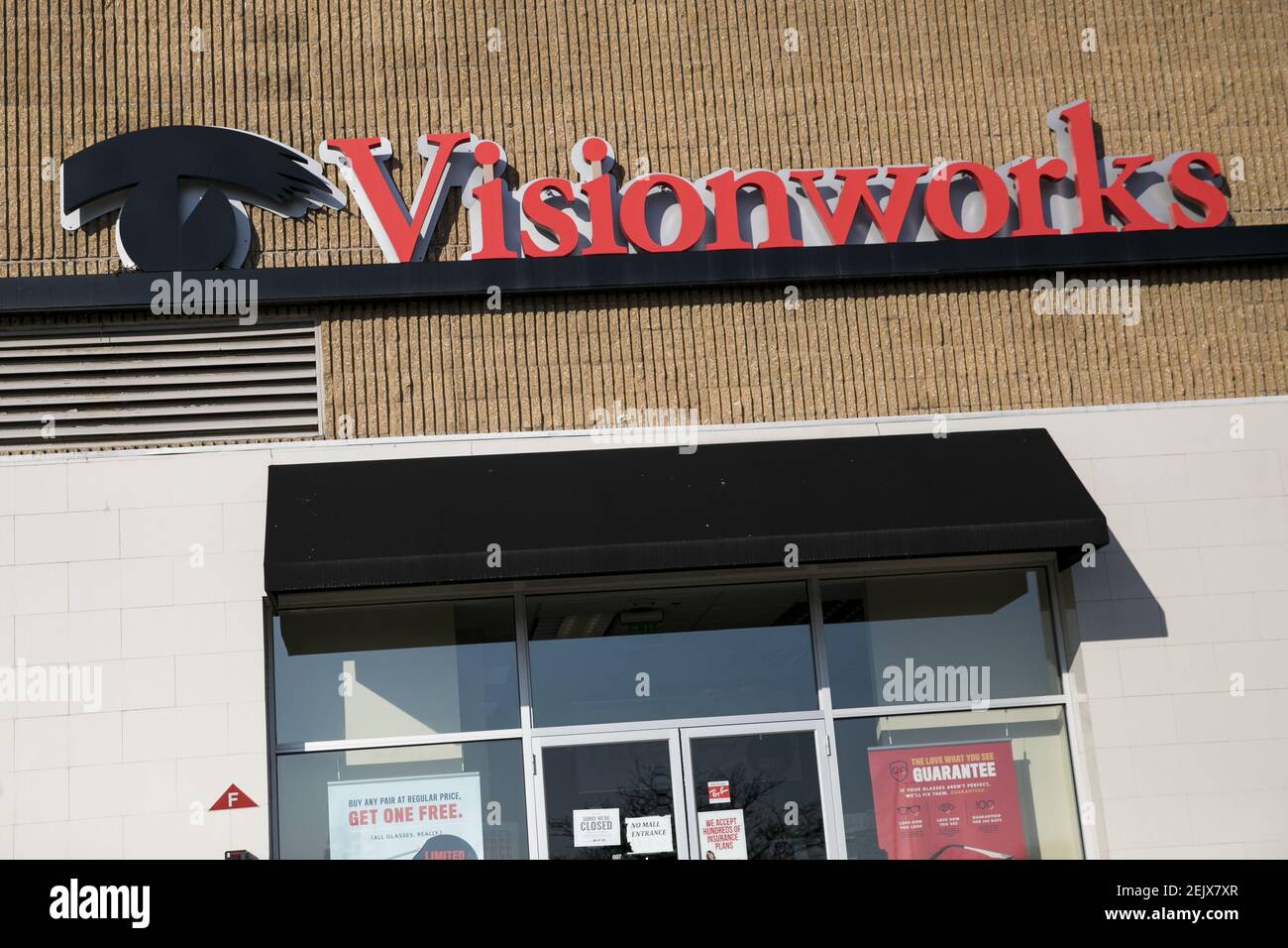 A logo sign outside of a Visionworks retail store location in North