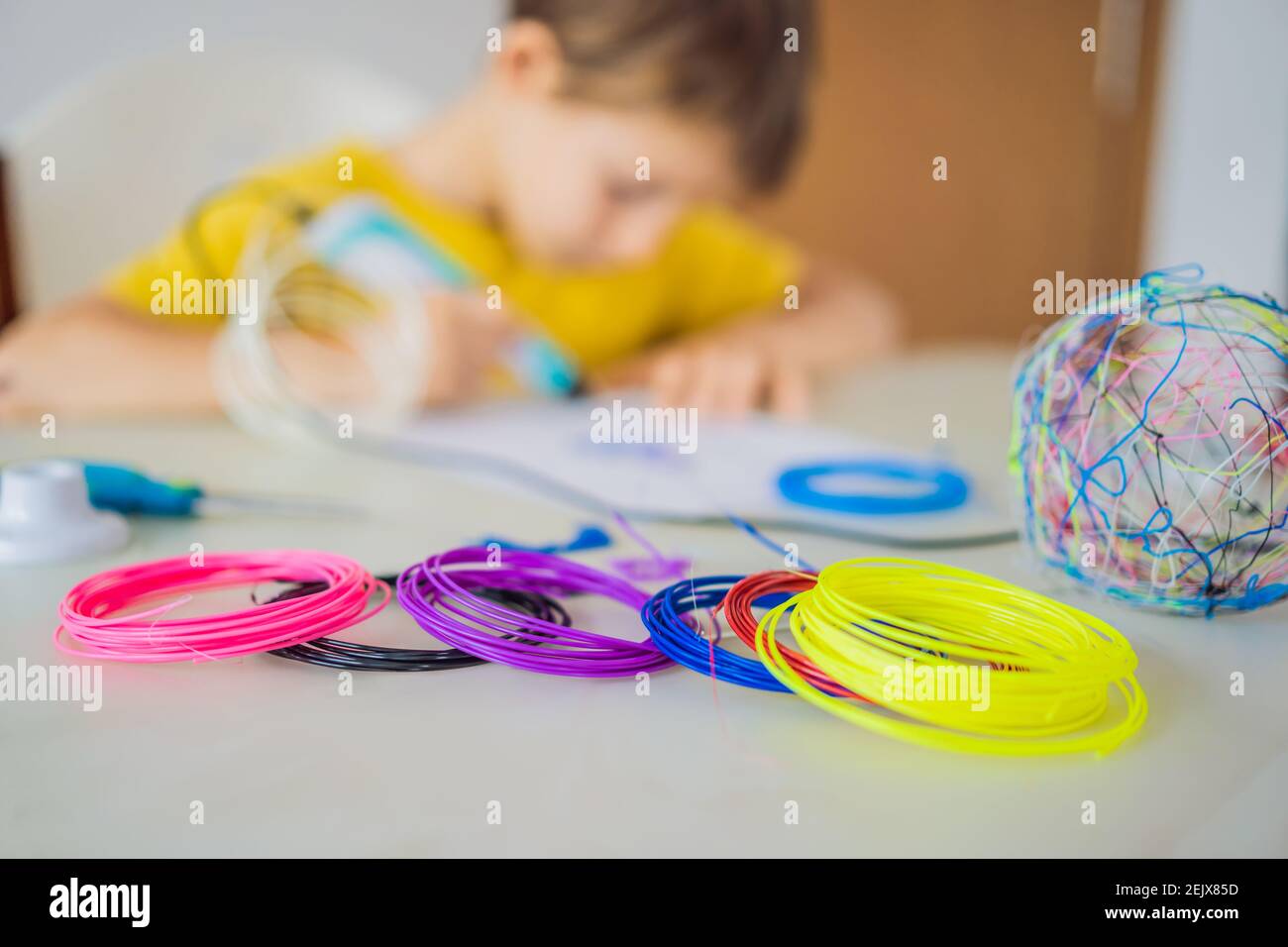 Kid using 3d printing drawing pen. Creative, leisure, technology education concept Stock Photo