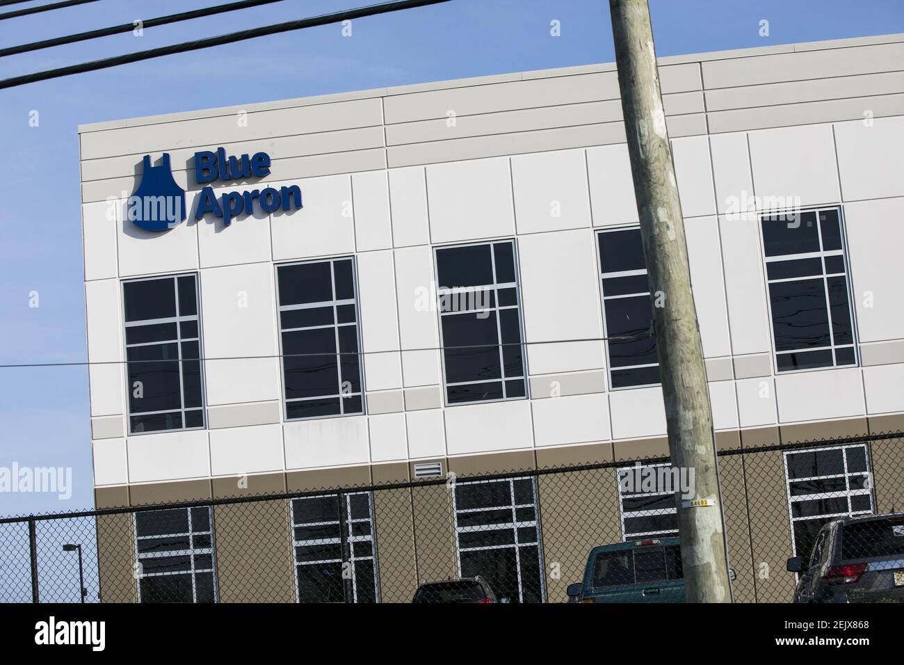 A logo sign outside of a facility occupied by Blue Apron in Linden, New