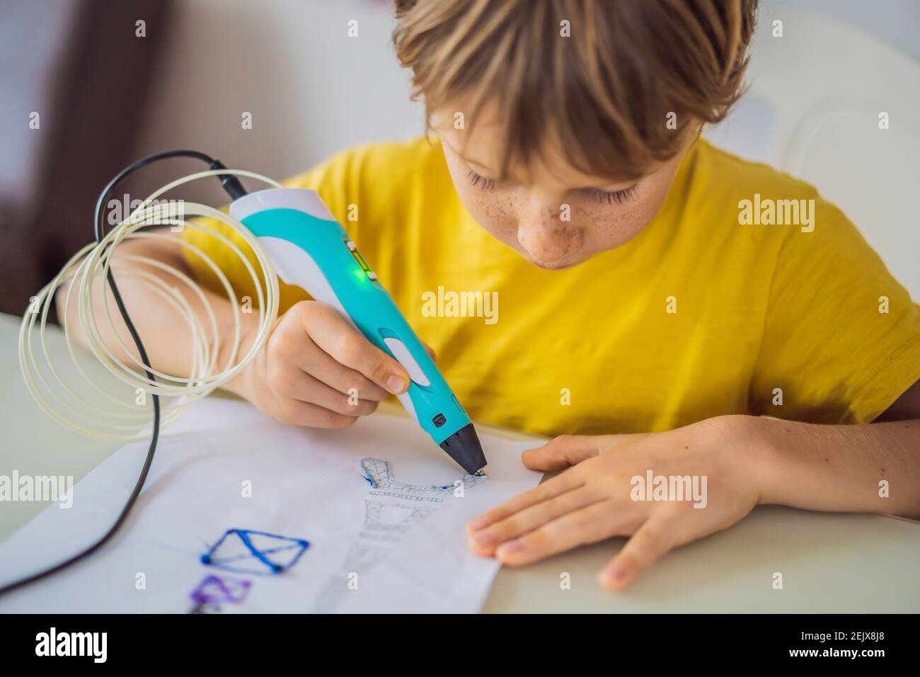 Kid using 3d printing drawing pen. Creative, leisure, technology education concept Stock Photo