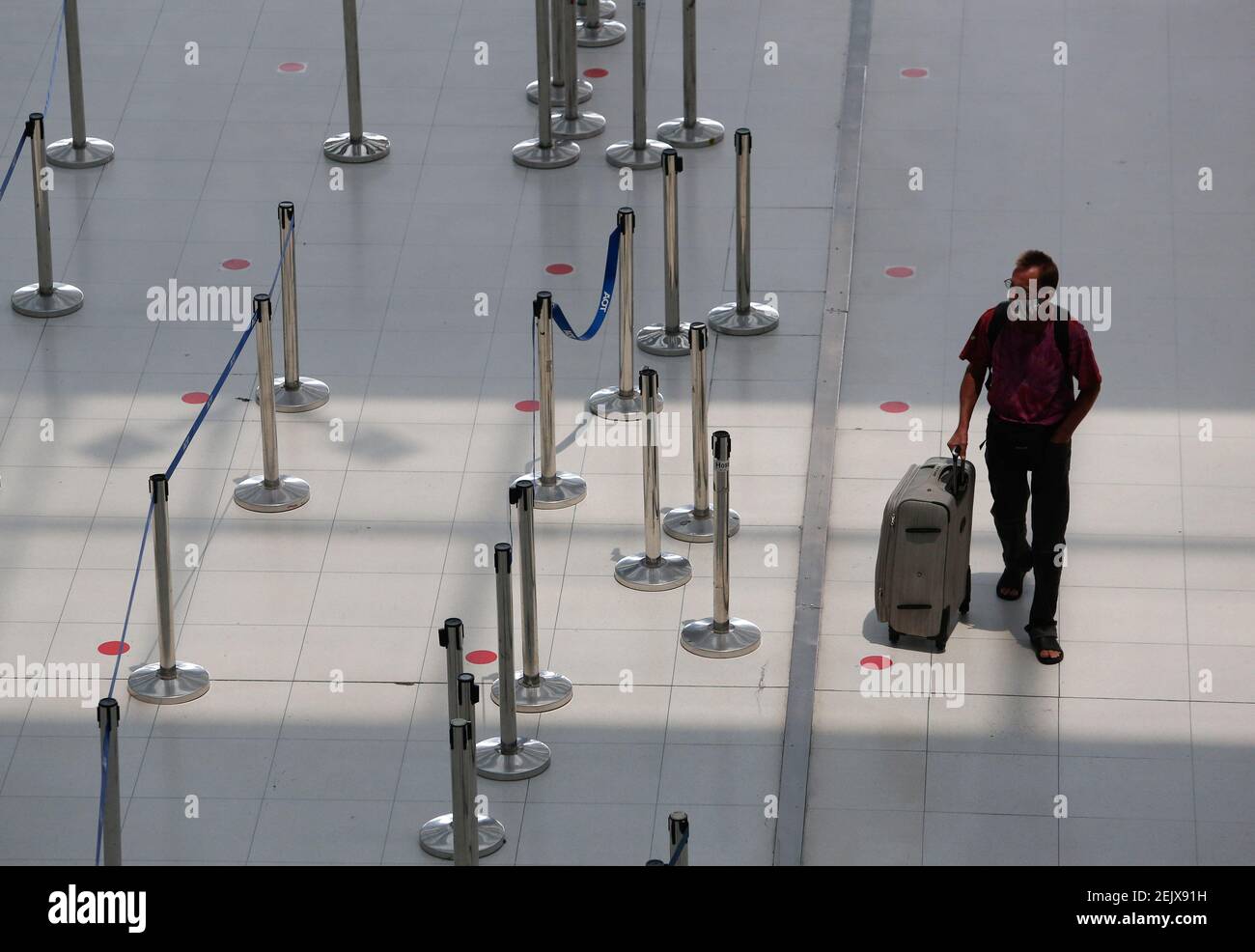 A tourist wears a face mask as a precaution against the spread of