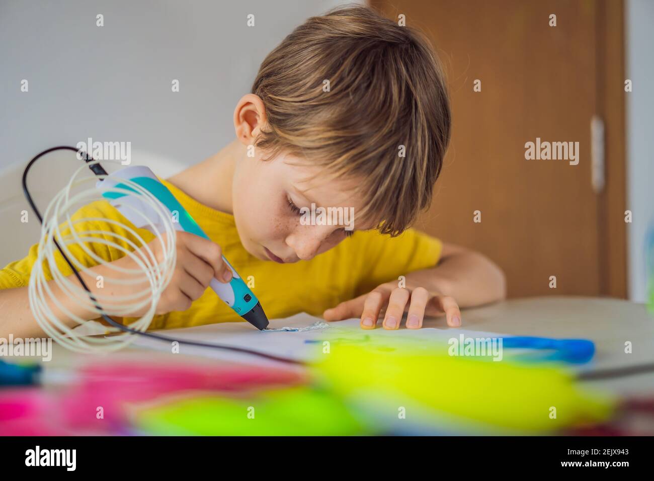 Kid using 3d printing drawing pen. Creative, leisure, technology education concept Stock Photo