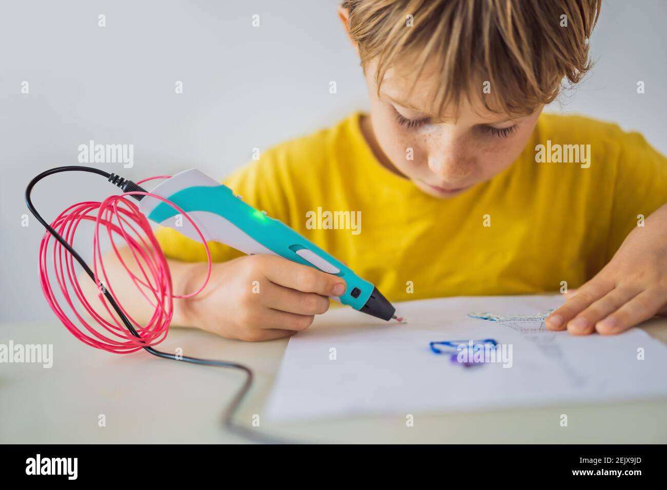 Kid using 3d printing drawing pen. Creative, leisure, technology education concept Stock Photo