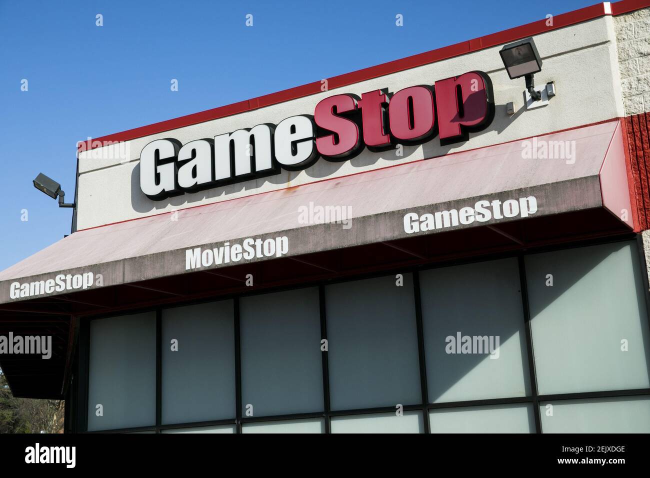 A logo sign outside of a GameStop retail store location in Towson ...