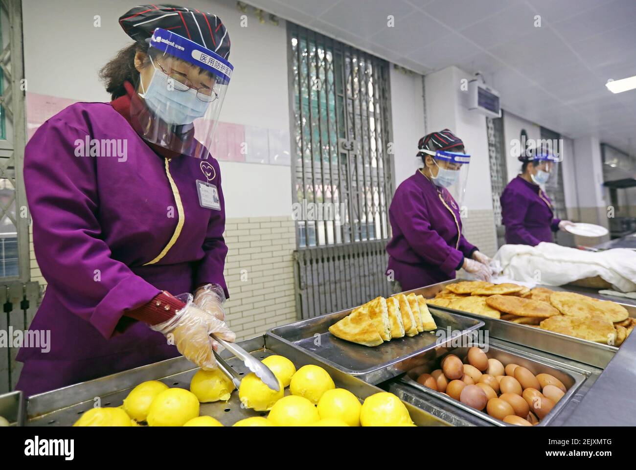 Canteen staff prepare food for students in Xi'an Tieyi Middle School in