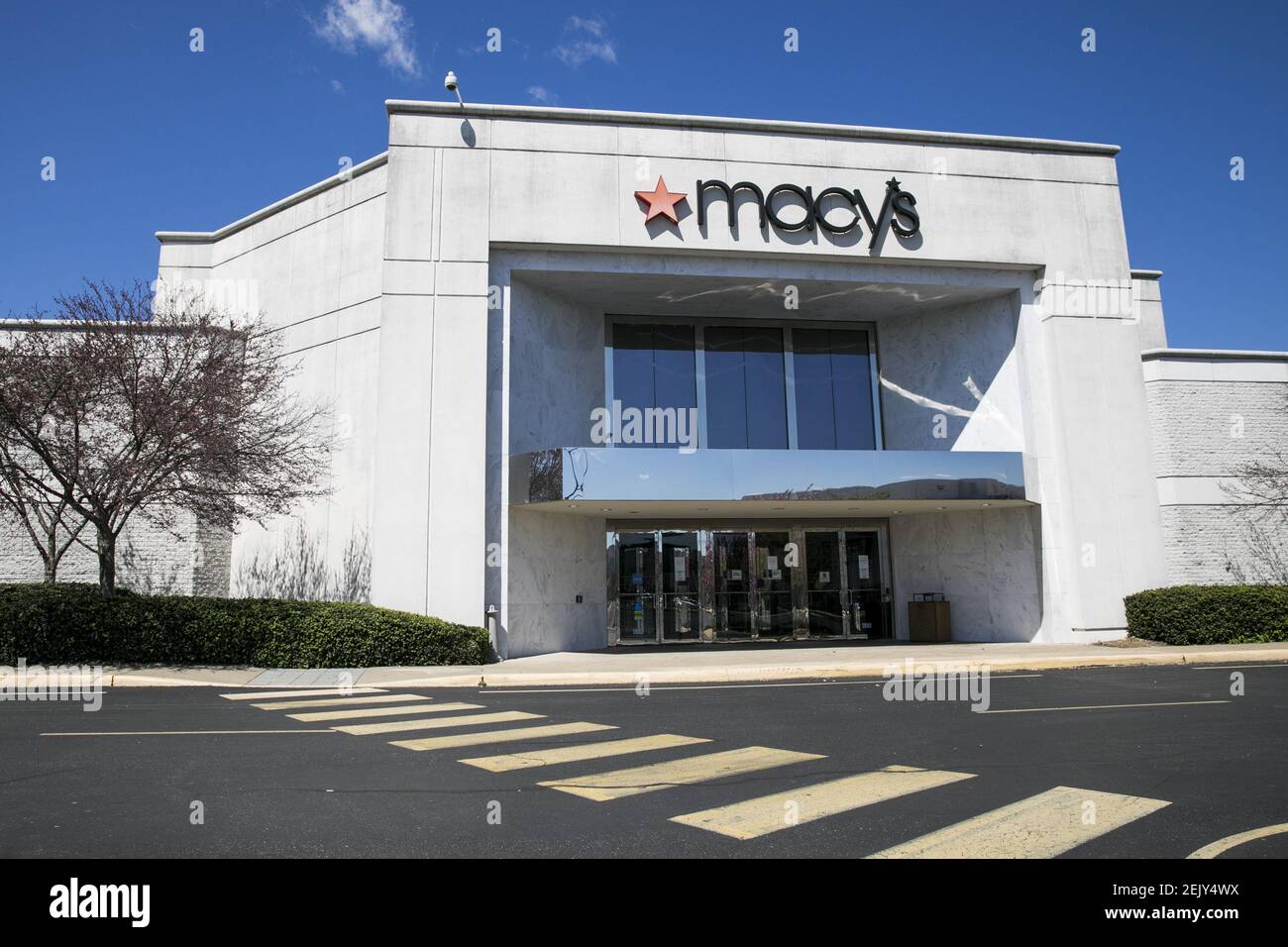 A logo sign outside of a Macy's retail store location in Fredericksburg