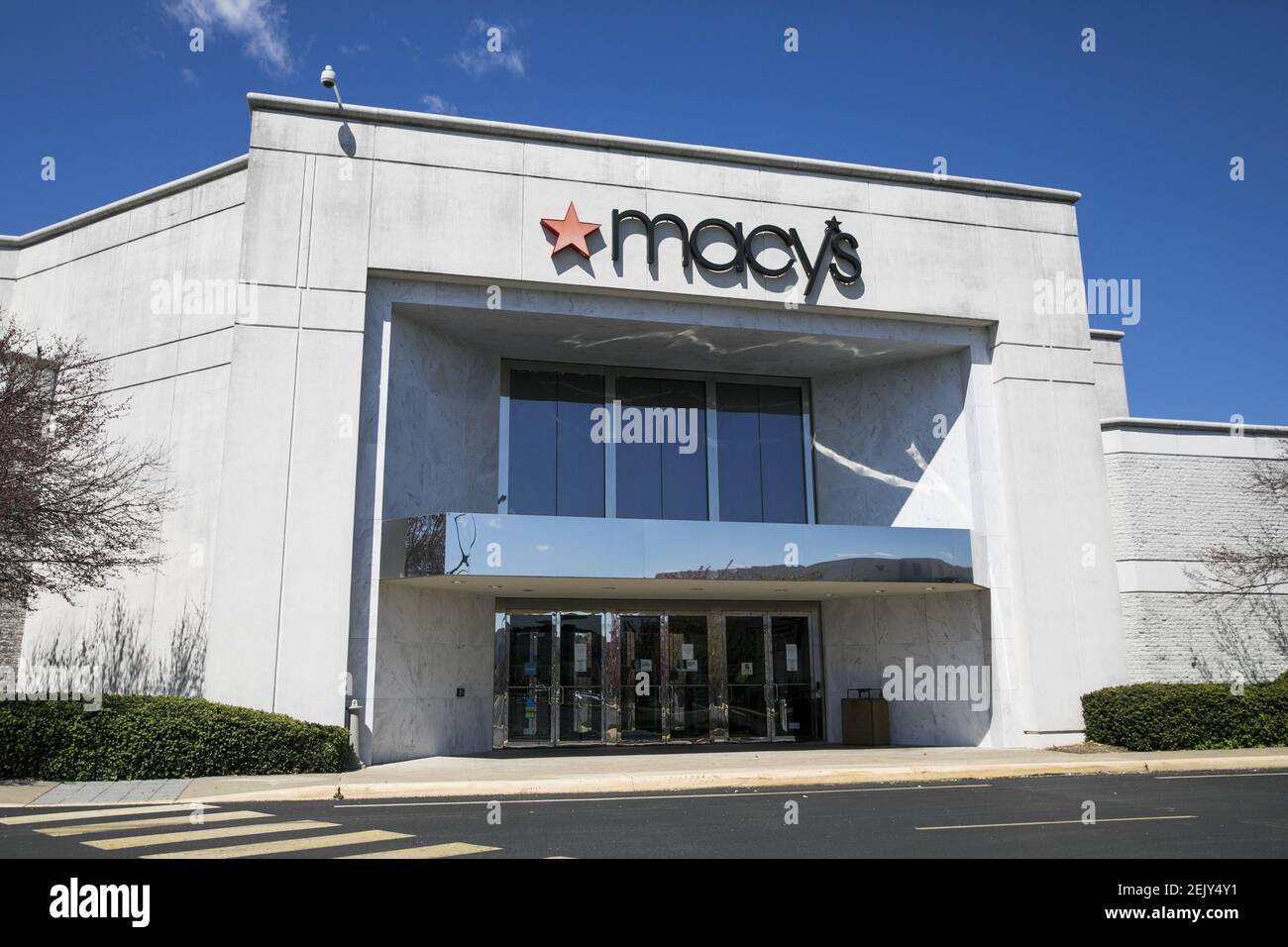 A logo sign outside of a Macy's retail store location in Fredericksburg