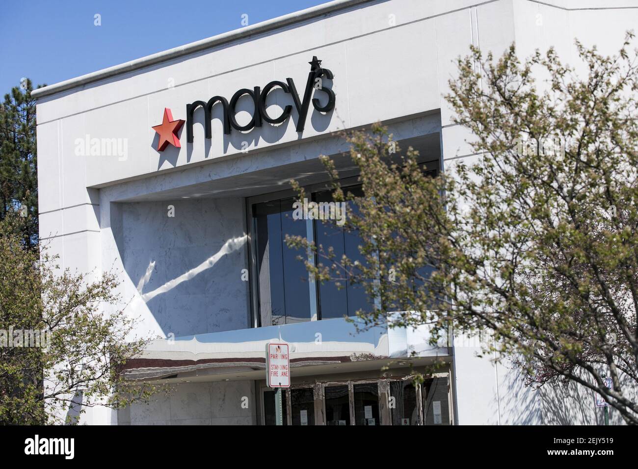 A logo sign outside of a Macy's retail store location in Fredericksburg