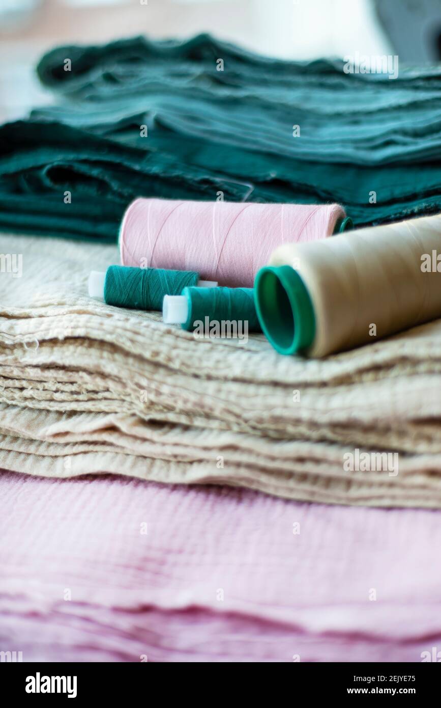 Vertical textile background. Cotton muslin fabrics of different colors