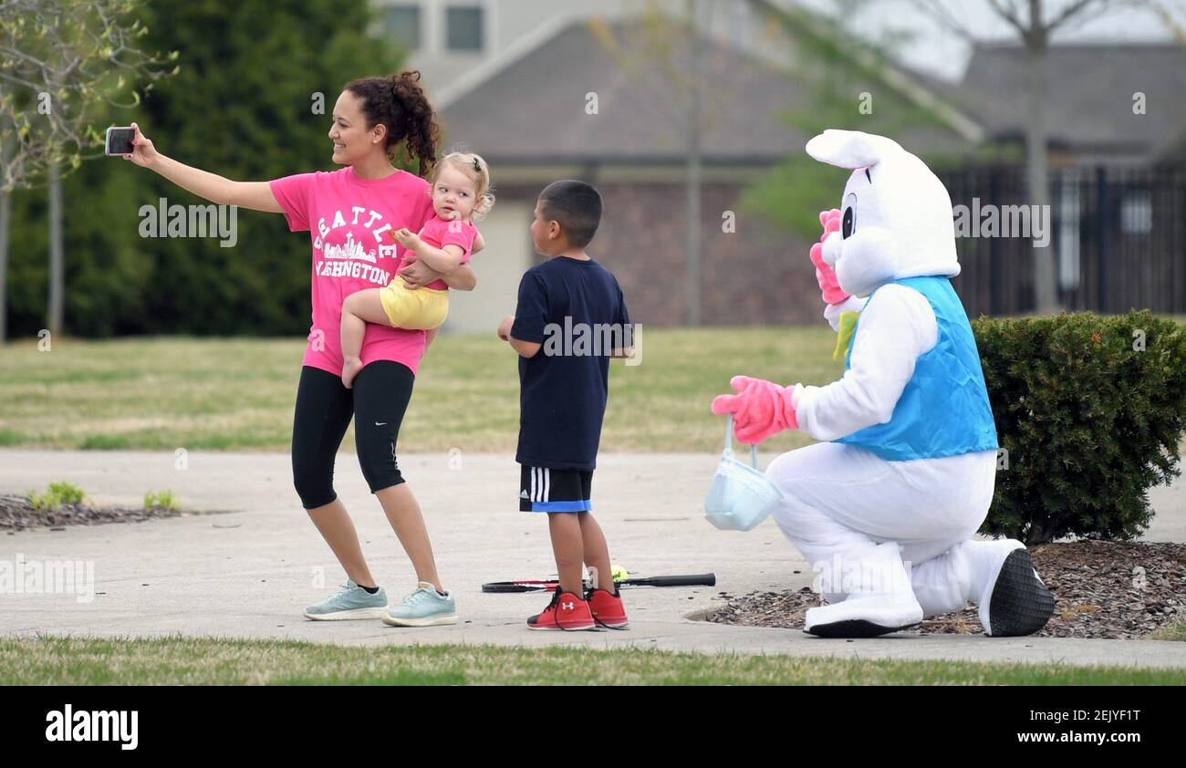Residents take a selfie with the Easter Bunny as he rides his bike giving candy to families in the Canterbury neighborhood in Tennessee in Thompsonâ€™s Station on Wednesday, April 8, 2020. FedEx pilot and Thompsonâ€™s Station resident Domenic Vitro dresses up as the Easter Bunny and rides his bike around, greeting children. Sem 3753 (Photo by Shelley Mays/Nashville Tennessean/Imagn/USA Today Network/Sipa USA) Stock Photo