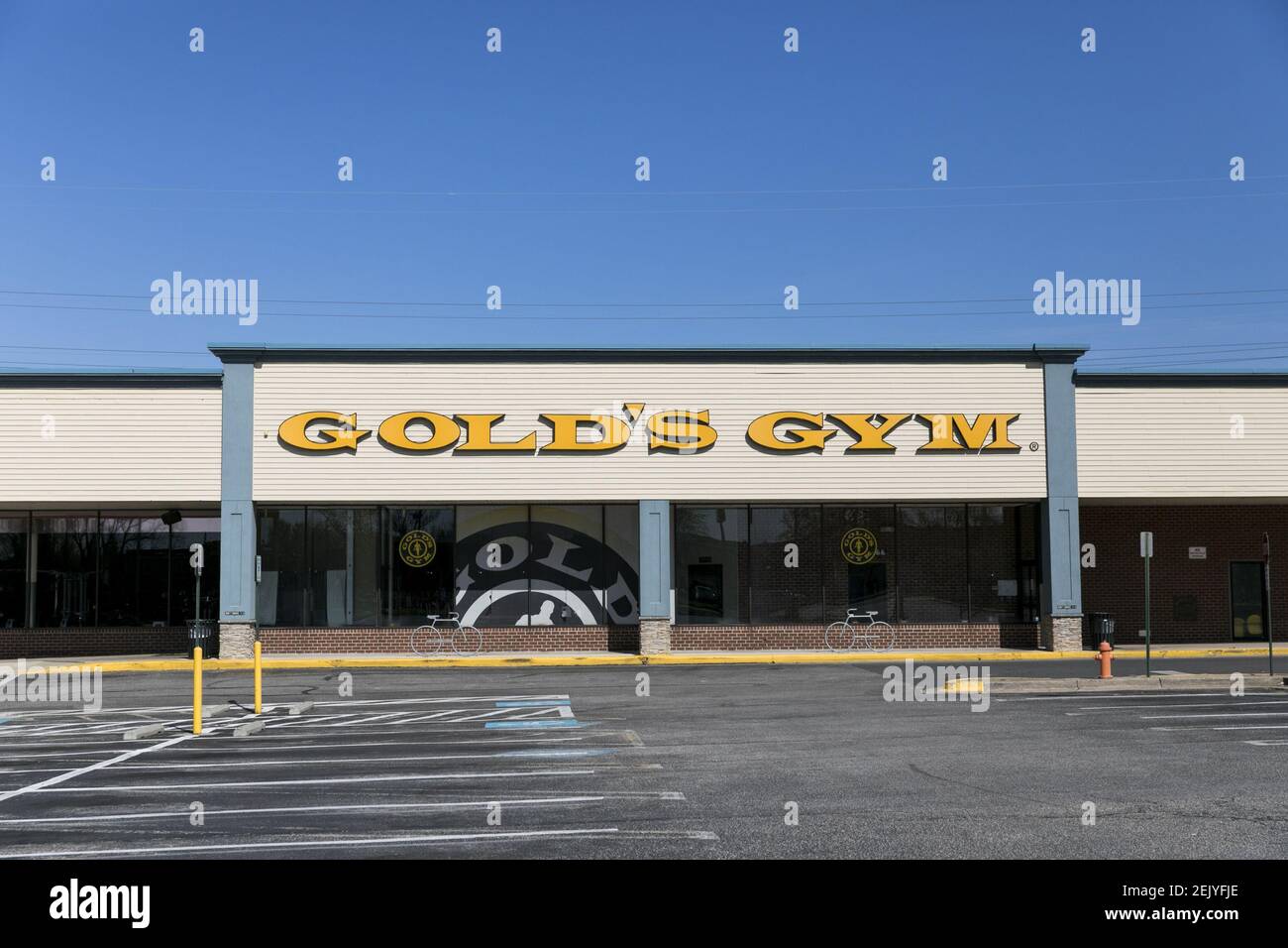 A logo sign outside of a Gold's Gym location in Dundalk, Maryland on