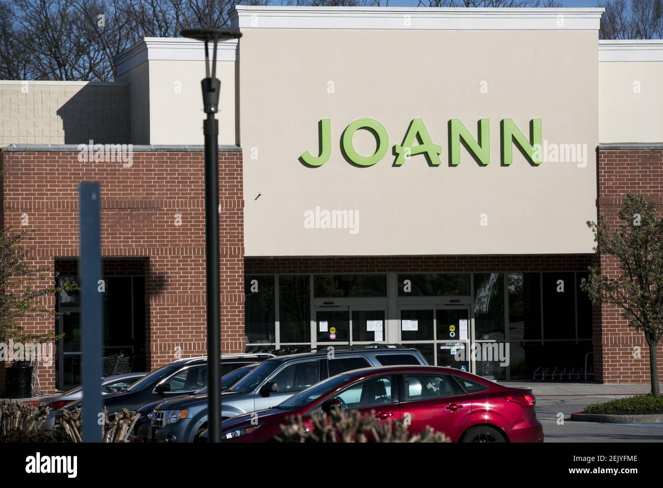 A logo sign outside of a JOANN Fabrics and Crafts retail store location