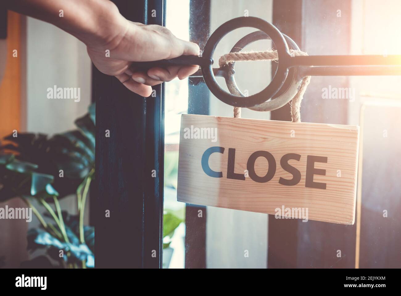 A Sign board of sorry we are closed hang on door of business shop background. Stock Photo