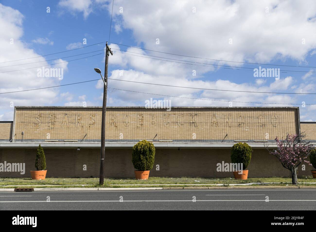 The faded outline of a logo sign outside of a closed and abandoned