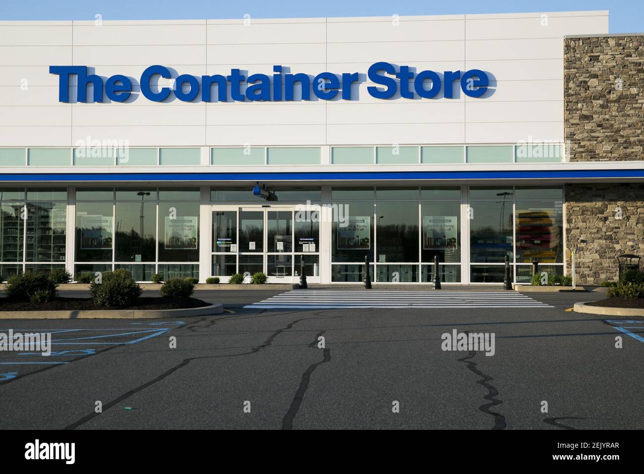 A logo sign outside of a The Container Store retail store location in ...