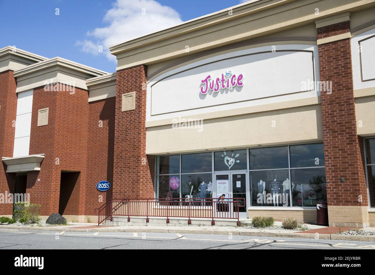 A logo sign outside of a Justice retail store location in Mays Landing ...