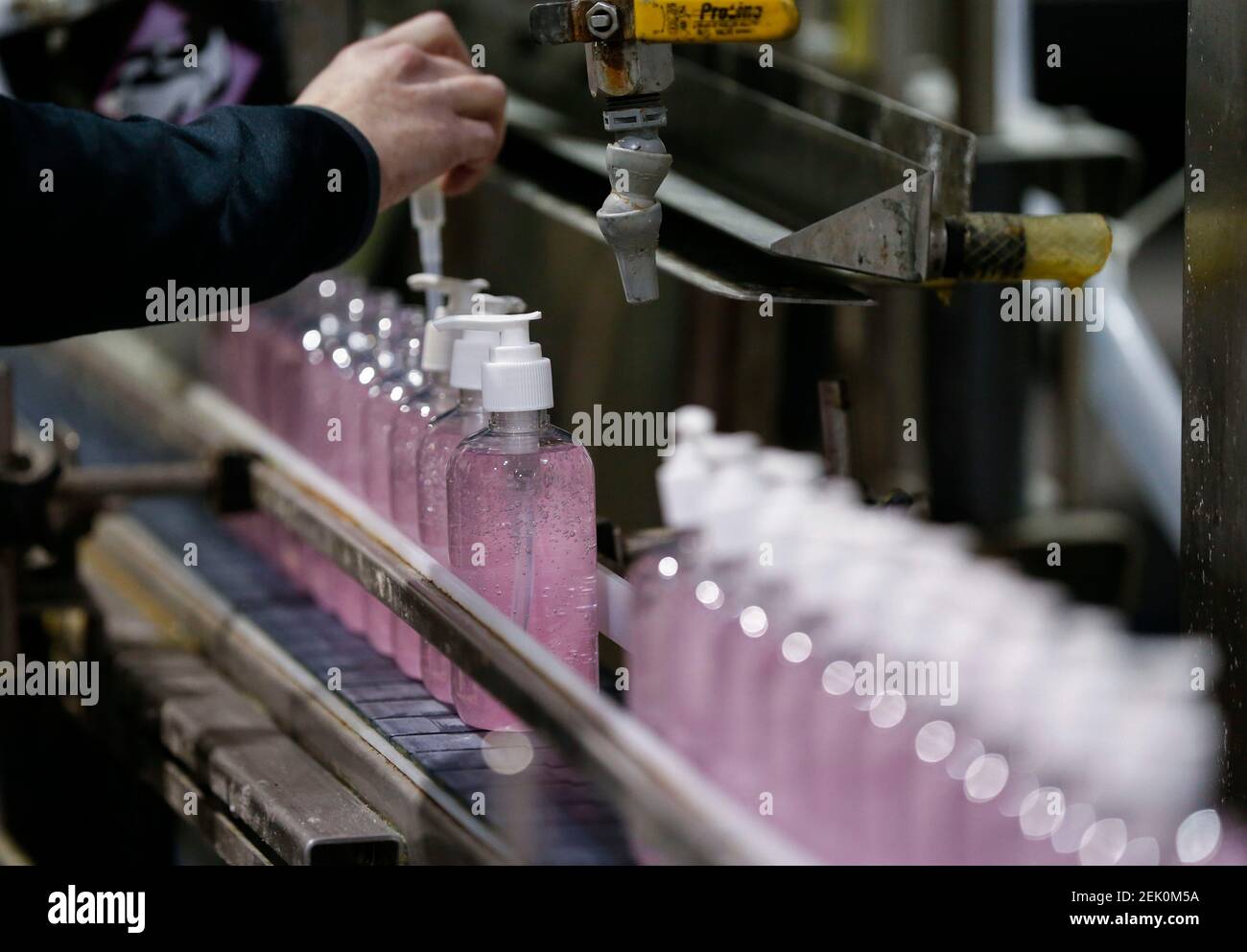 Ashley Roush places pumps on bottles of hand sanitizer as she works on a production line at Aire-Master in Nixa on Wednesday, April 22, 2020. Tairemaster00096 (Photo by Nathan Papes/Springfield News-Leader, Springfield News-Leader via Imagn Content Services, LLC/USA Today Network/Sipa USA) Stock Photo