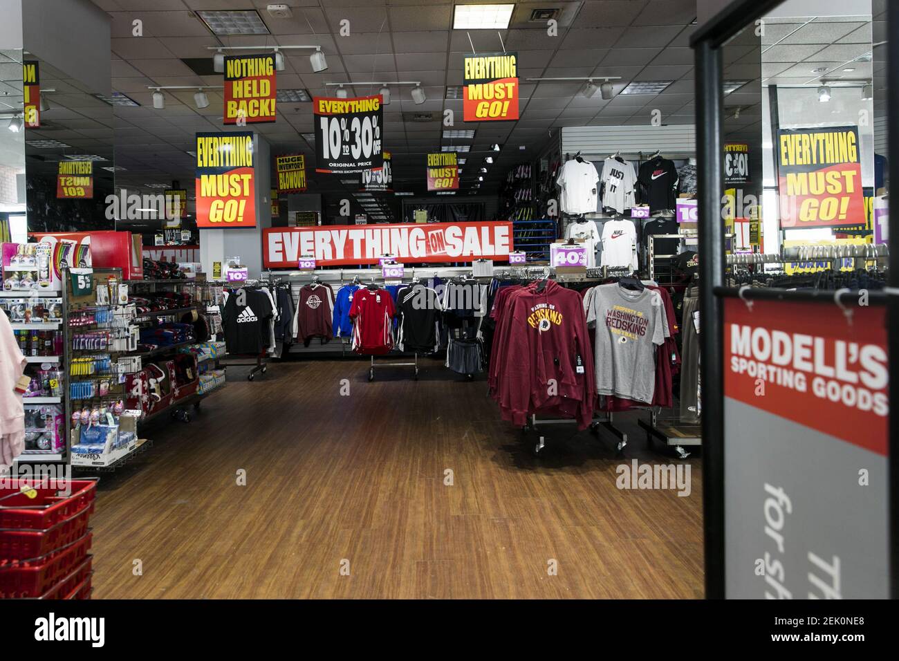 'Everything Must Go' signage inside a Modell's Sporting Goods retail