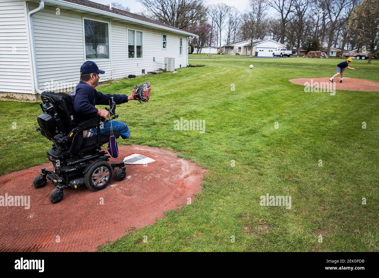 Bob Gillum coaches two of his grandsons using the family's backyard pitching mound Thursday, April 23, 2020. Pitchingfamily7t0a6568 (Photo by Jordan Kartholl / The Star Press, Muncie Star Press via Imagn Content Services, LLC/USA Today Network/Sipa USA) Stock Photo