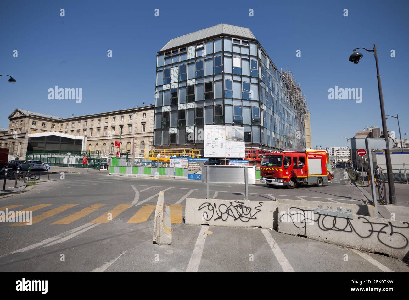 An ambulance drives down Rue de Maubeuge before pulling into the