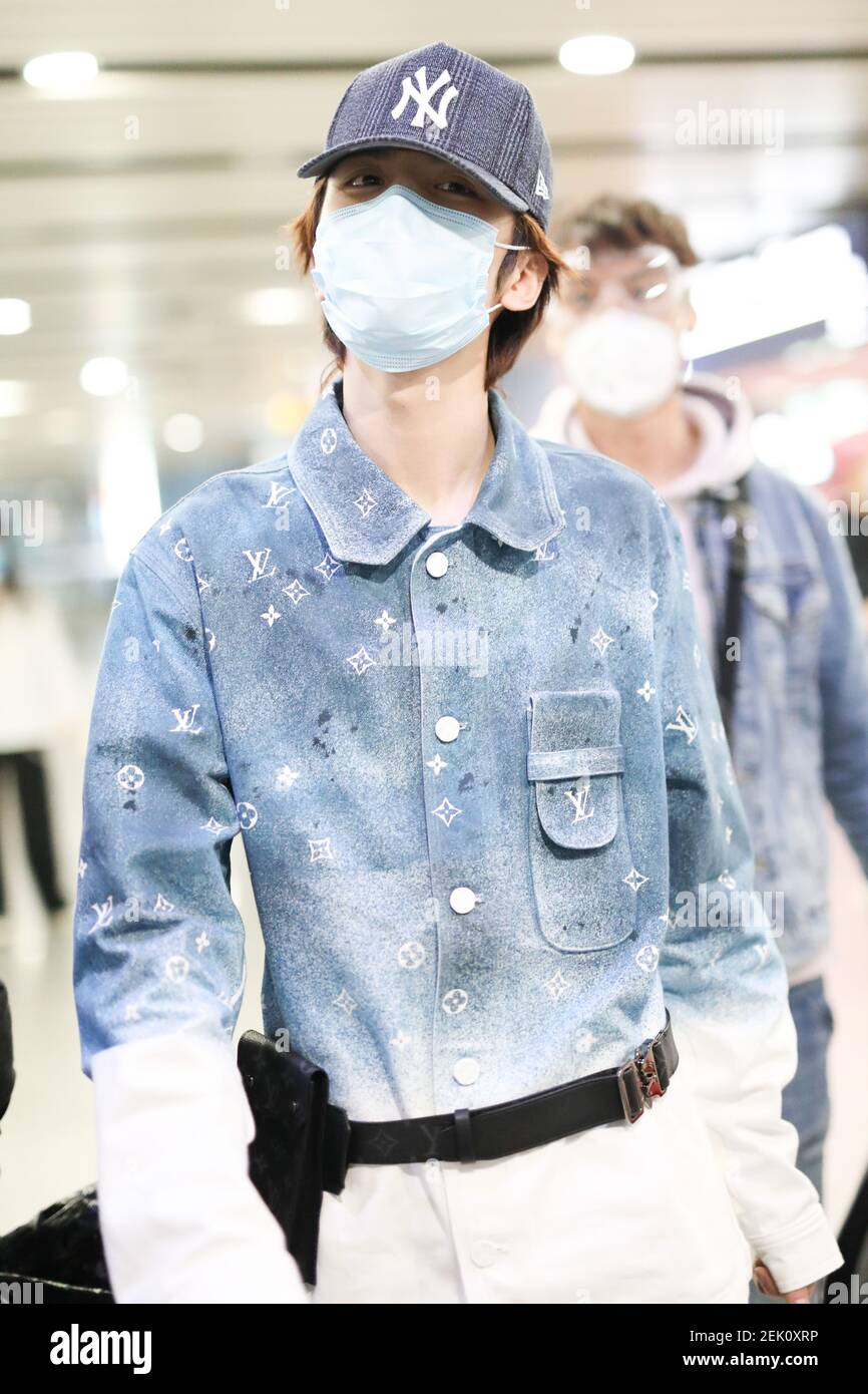 Chinese singer Ling Chao arrives at a Beijing airport before departure ...