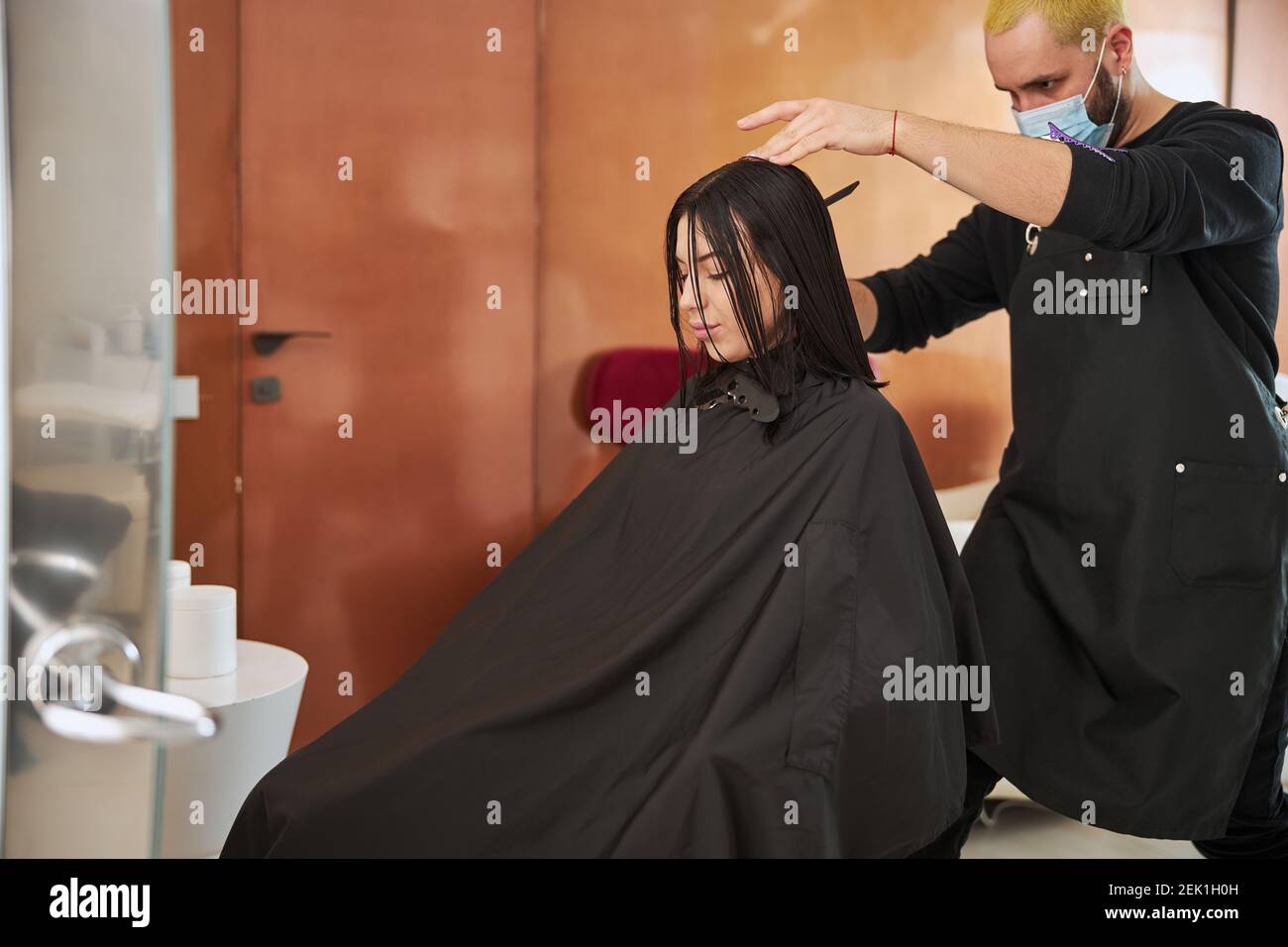 Young relaxed attractive customer getting her haircut Stock Photo