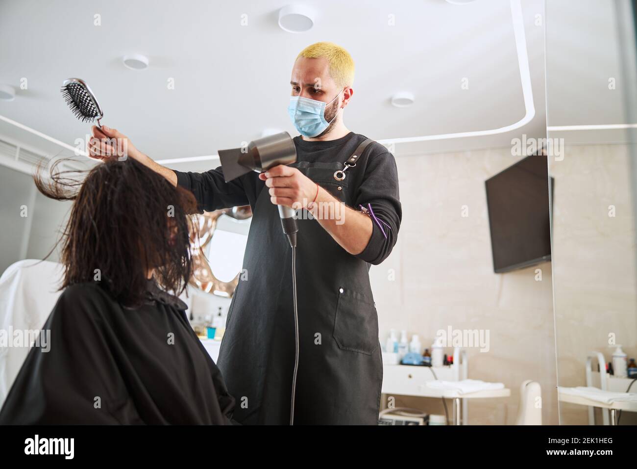 Close up woman using hair dryer hi-res stock photography and images - Alamy