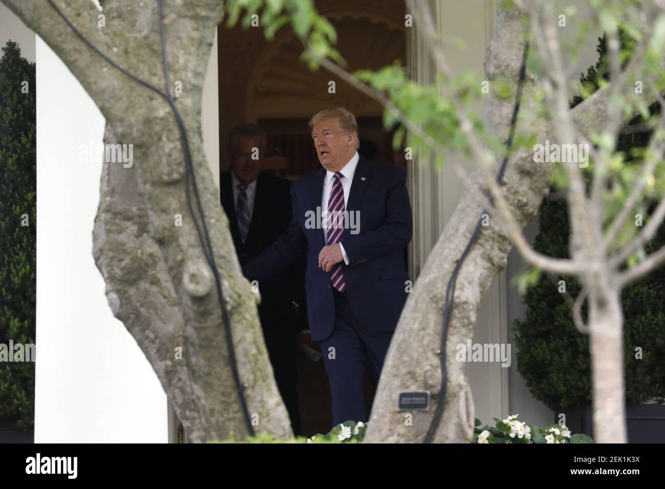 U.S. President Donald Trump walks out from the Oval Office of the White ...
