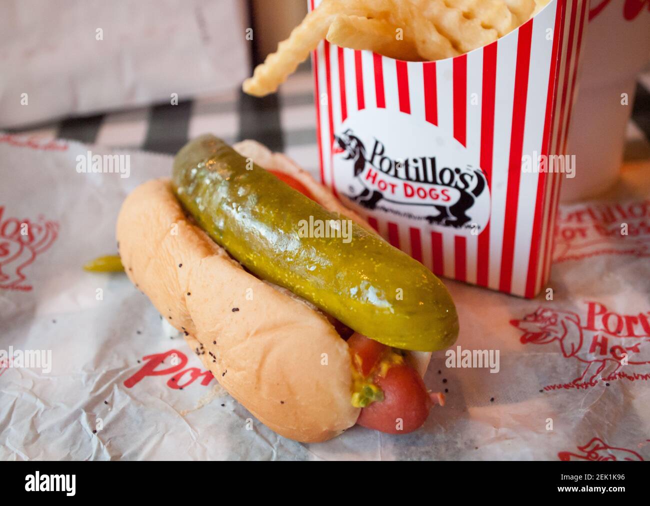 A classic Chicago-style hot dog and crinkle French fries from Portillo's Hot Dogs in Chicago, Illinois. Stock Photo