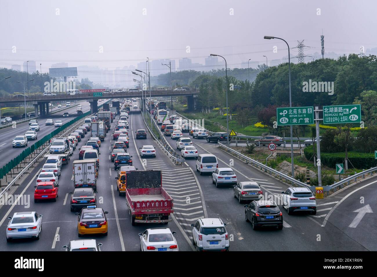 An aerial view of the traffic stream moving slowly on the road after