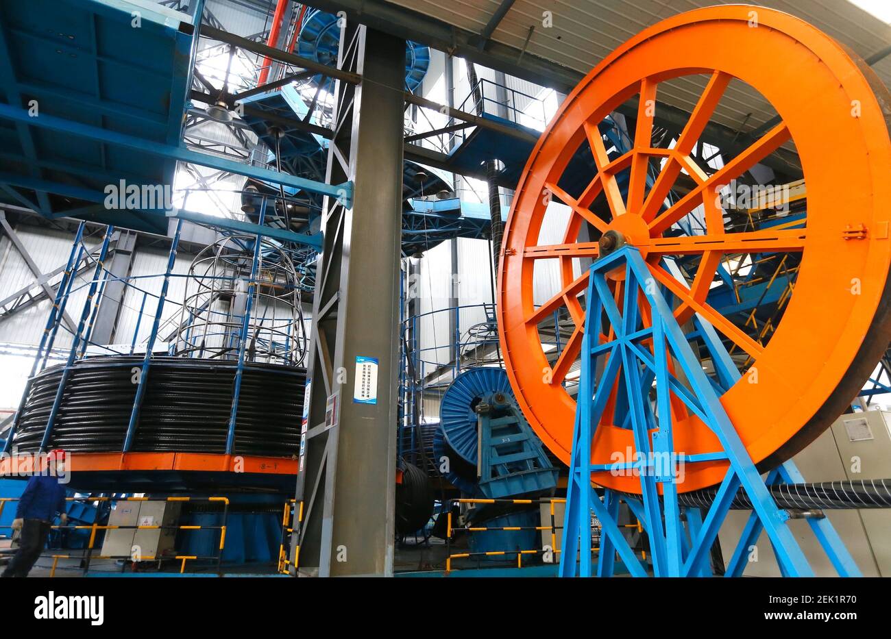 Subcom Cable Factory With the help of machines, workers produce submarine communication ...