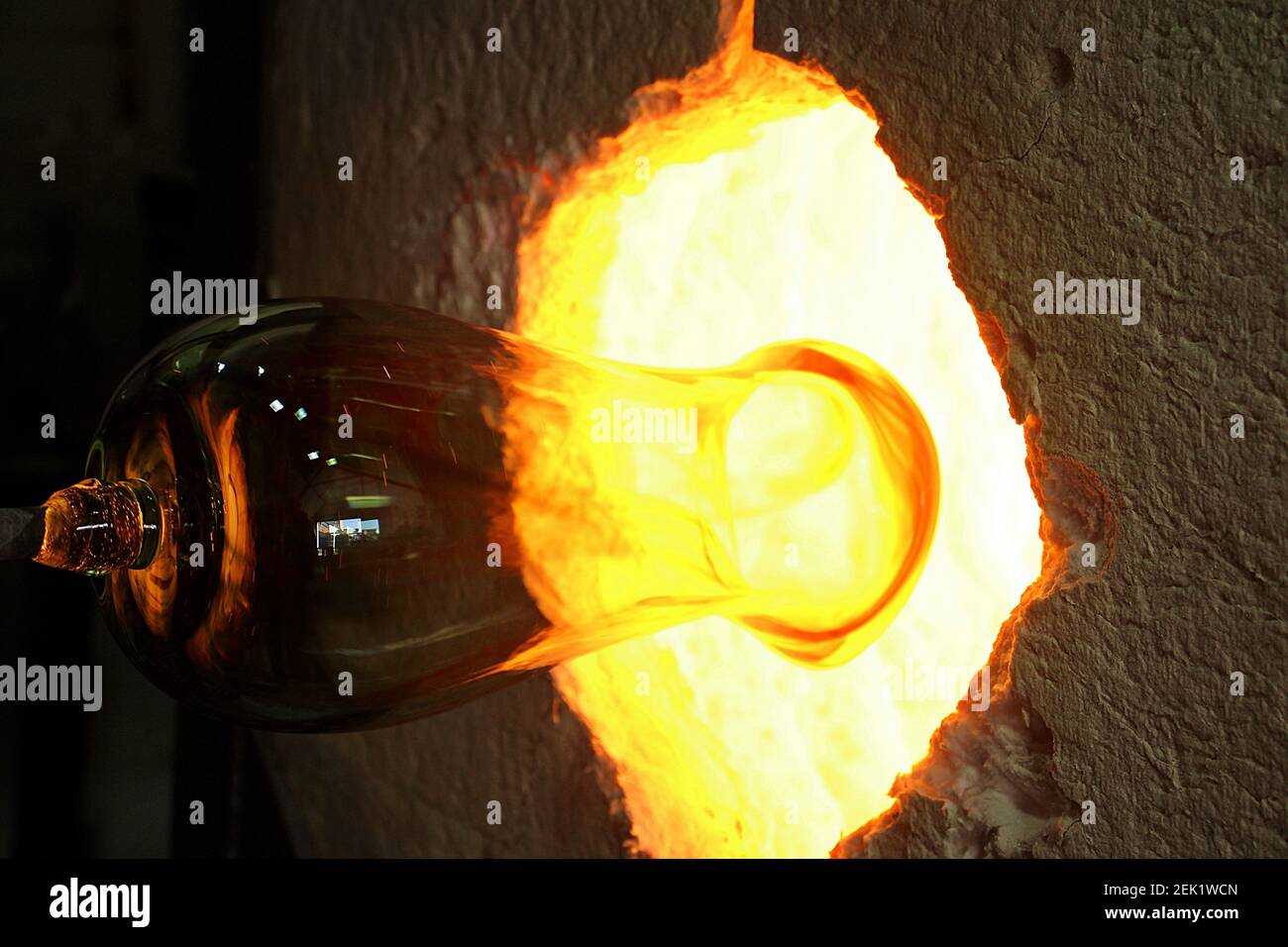 heating glass for blowing in a kiln ready for attaching the base Stock