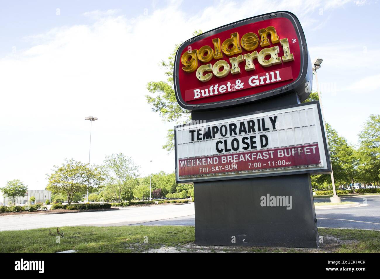 A logo sign outside of a Golden Corral restaurant location in