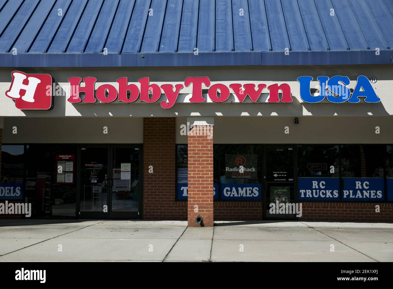 A logo sign outside of a HobbyTown USA retail store location in Newport