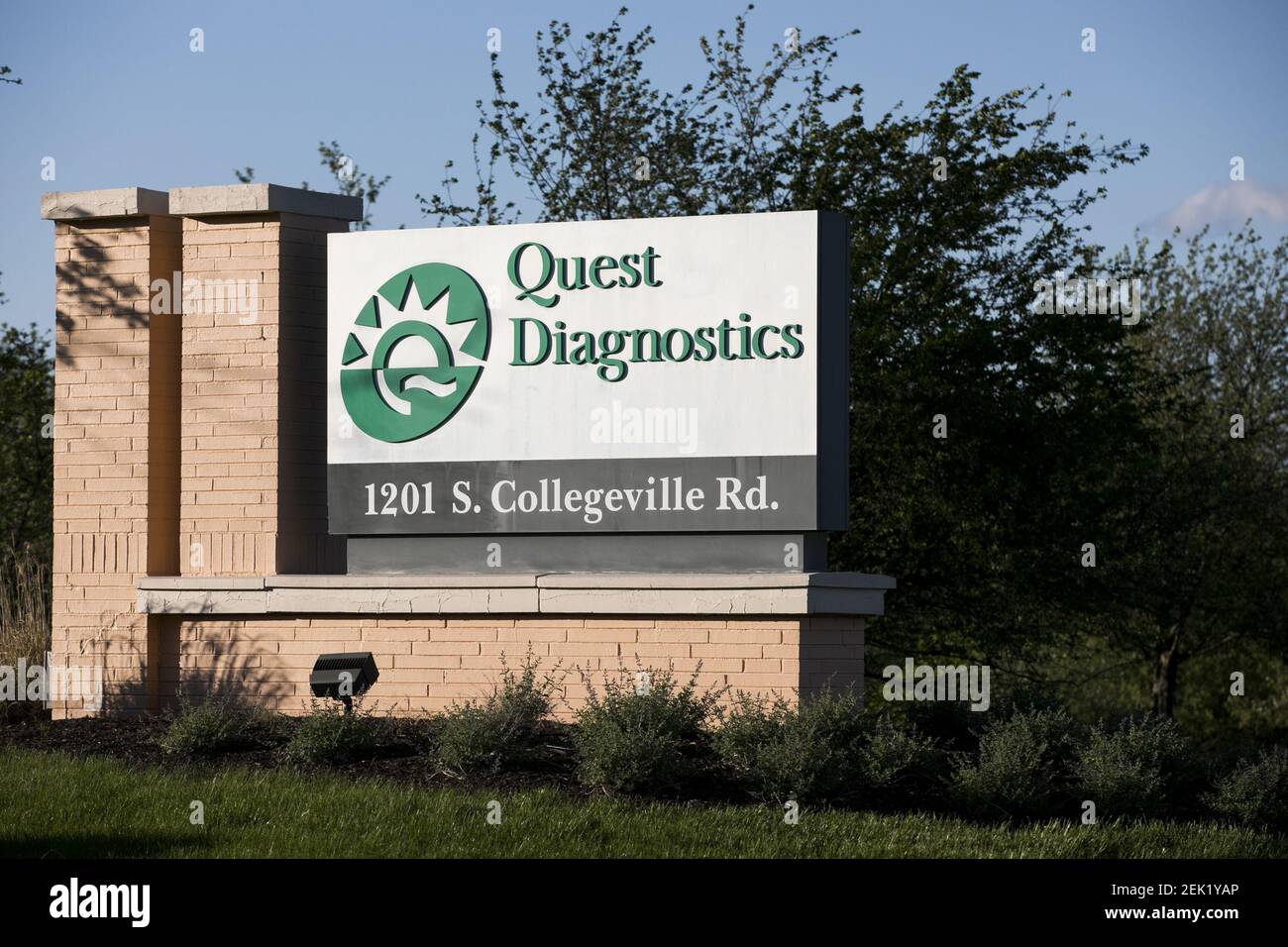 A logo sign outside of a facility occupied by Quest Diagnostics in