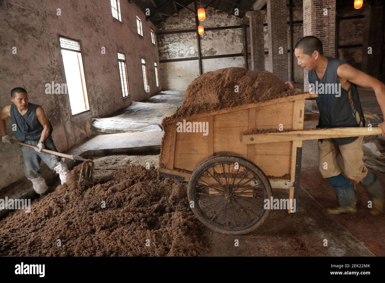 JInagsuï¼ŒCHINA-On May 7, 2020, in the yisheng century-old cellar pool and brewing workshop located in changle town, haimen, jiangsu province, the brewing workers followed the traditional craft brewing process, mixing fermented grains with distillers' grains, hauling distillers' grains, steaming liquor on the steamer, and brewing the original liquor.(EDITORIAL USE ONLY. CHINA OUT) (Photo by /Sipa USA) Stock Photo